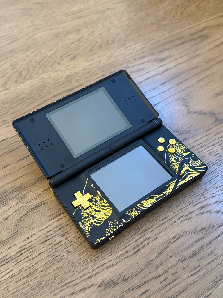 The same DS Lite opened after a gold wave reshell.