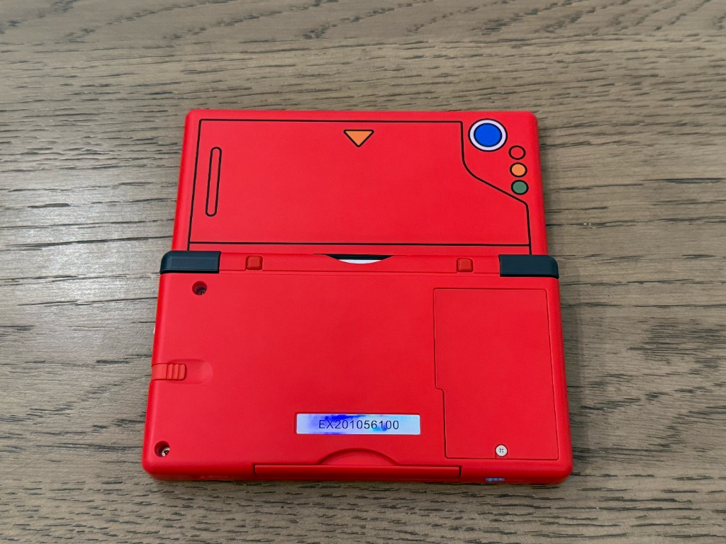 The back of a red Pokedex-style DS Lite shell.