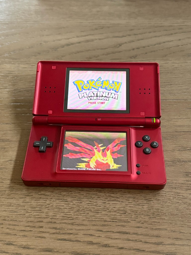 A red DS Lite opened and powered on after a reshell, showing Pokémon Platinum.