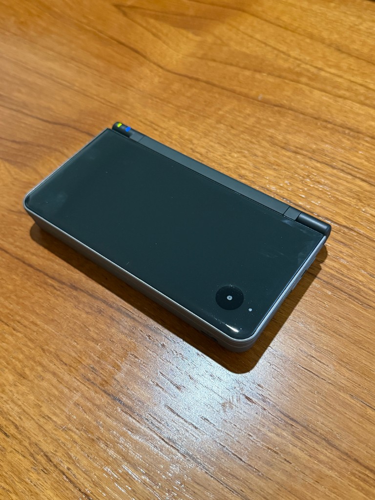 The reshelled black DSi XL, closed.
