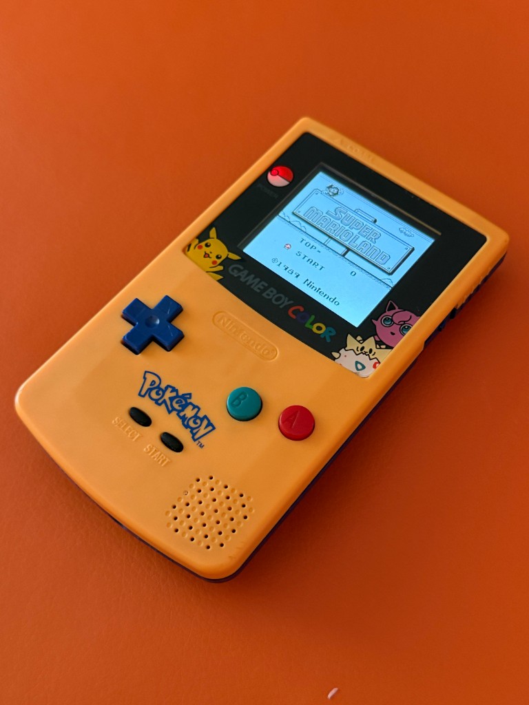 The same Pokémon edition Game Boy Color after an IPS screen, with Super Mario Land bright and backlit.